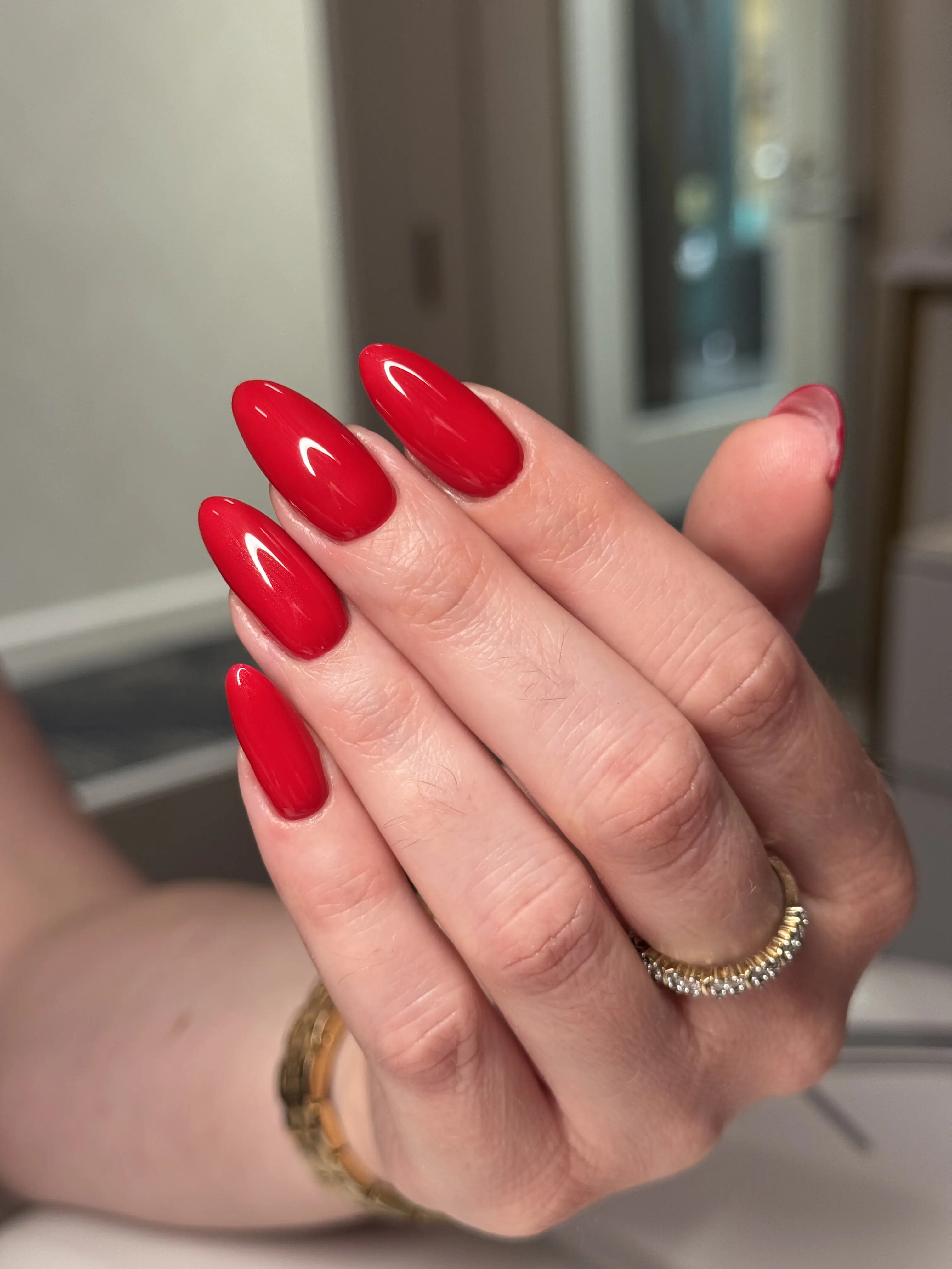 Long almond nails in solid bright red gel polish