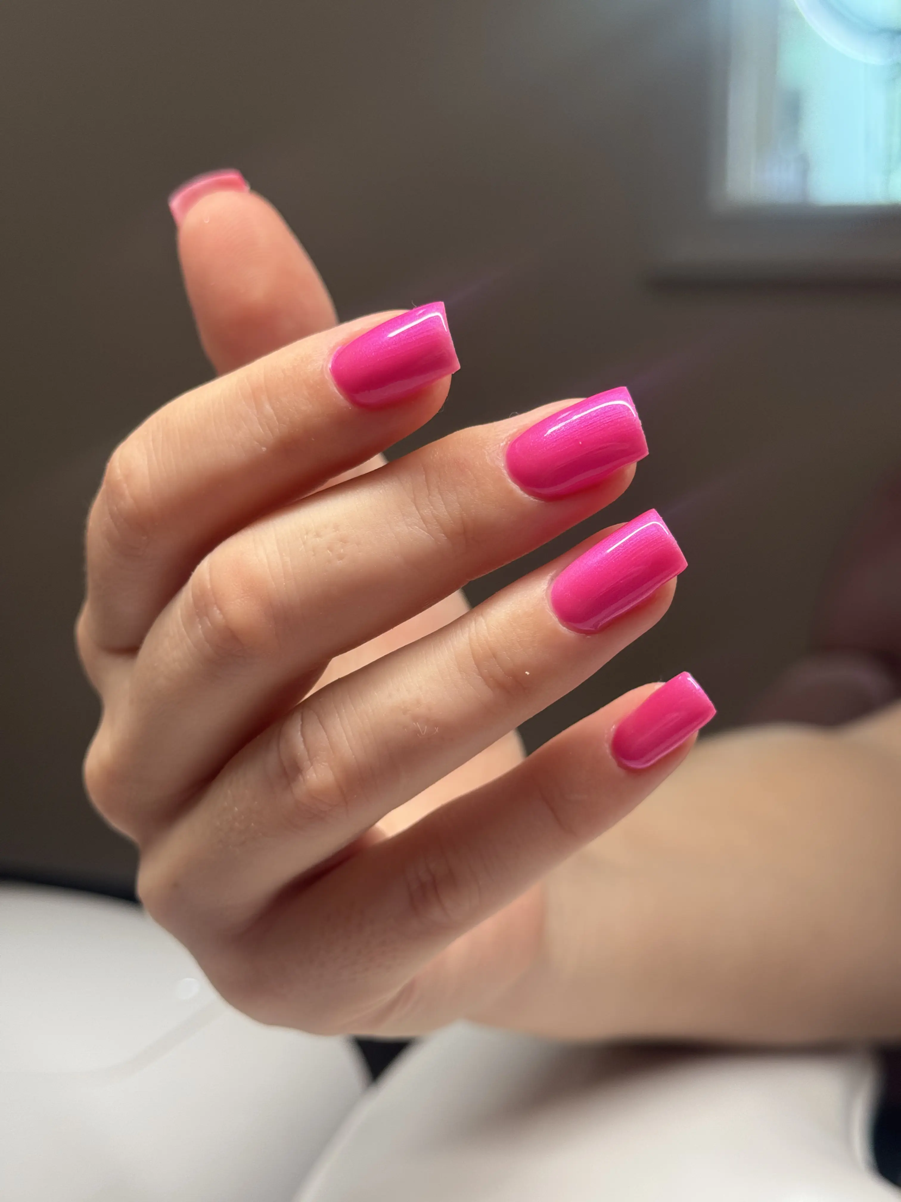 Medium-length square nails in glossy magenta-pink gel polish