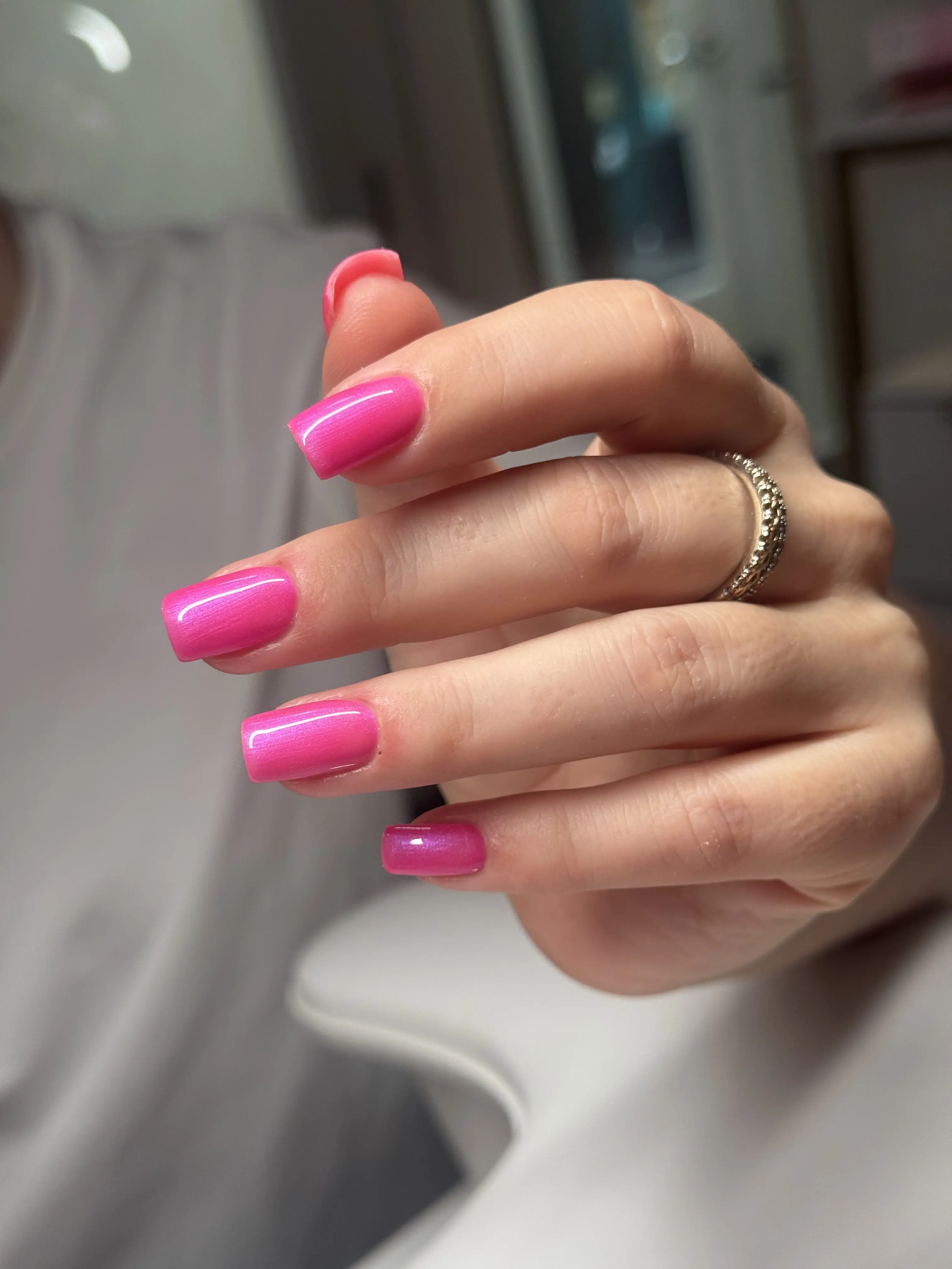 Short square nails in shimmer pink gel polish with a satin cat-eye finish